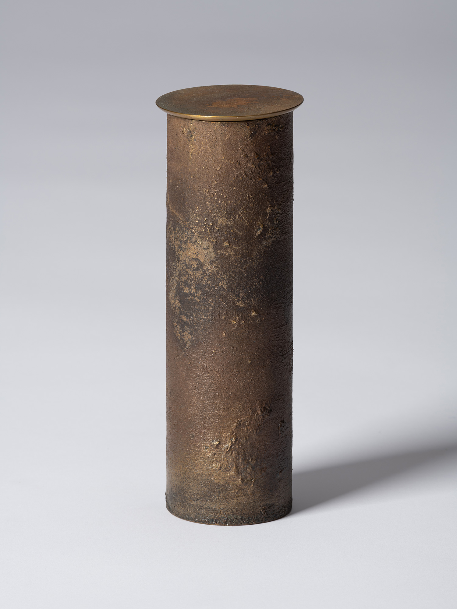 Front view of Koji Hatakeyama’s bronze as Bronze II No. 33, a tall cylindrical bronze vessel with...