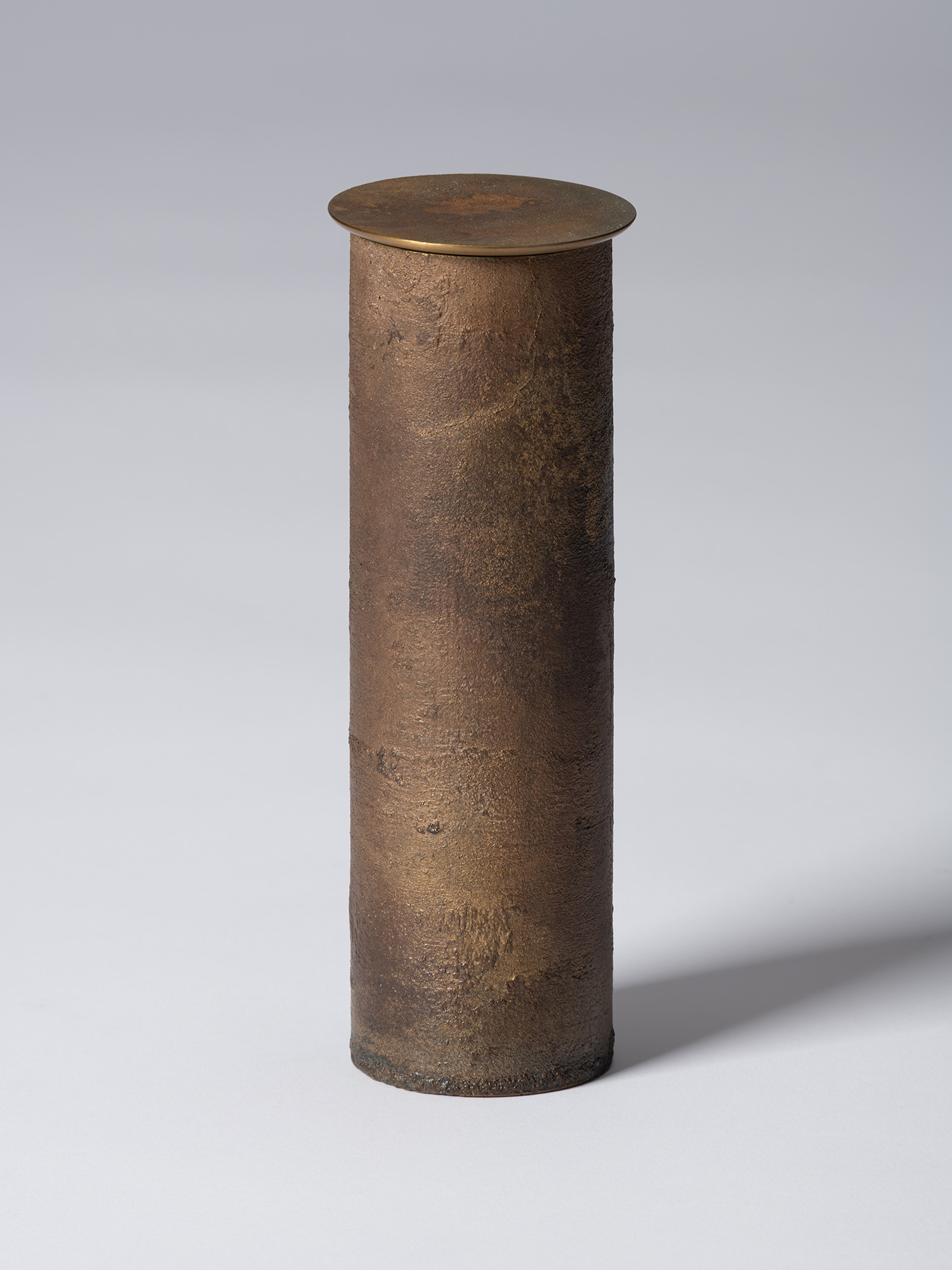 Front view of Koji Hatakeyama’s bronze as Bronze II No. 33, a tall cylindrical bronze vessel with...