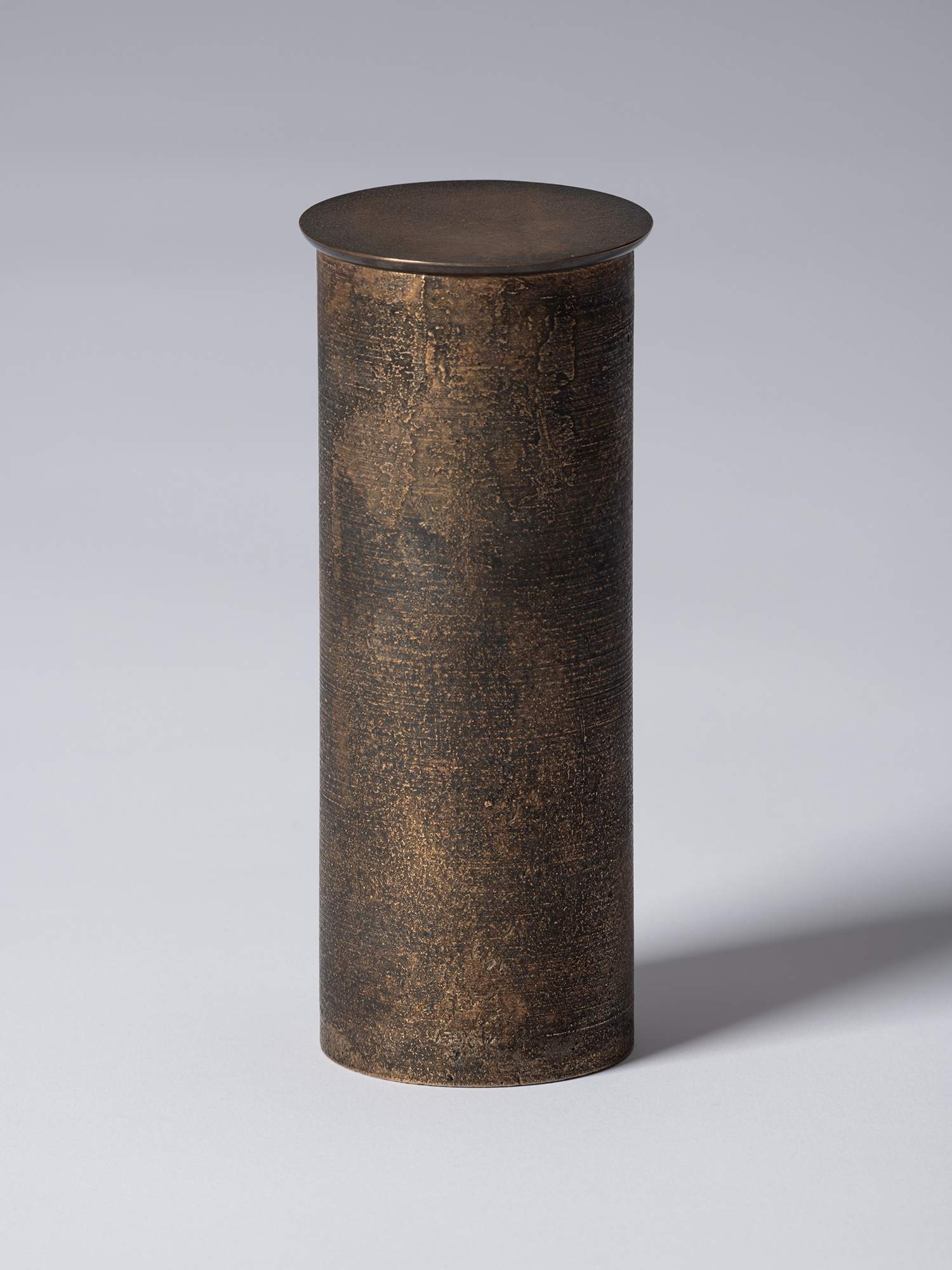 bronze as Bronze II No. 17 by Koji Hatakeyama, a tall cylindrical bronze vessel with a fitted circular...