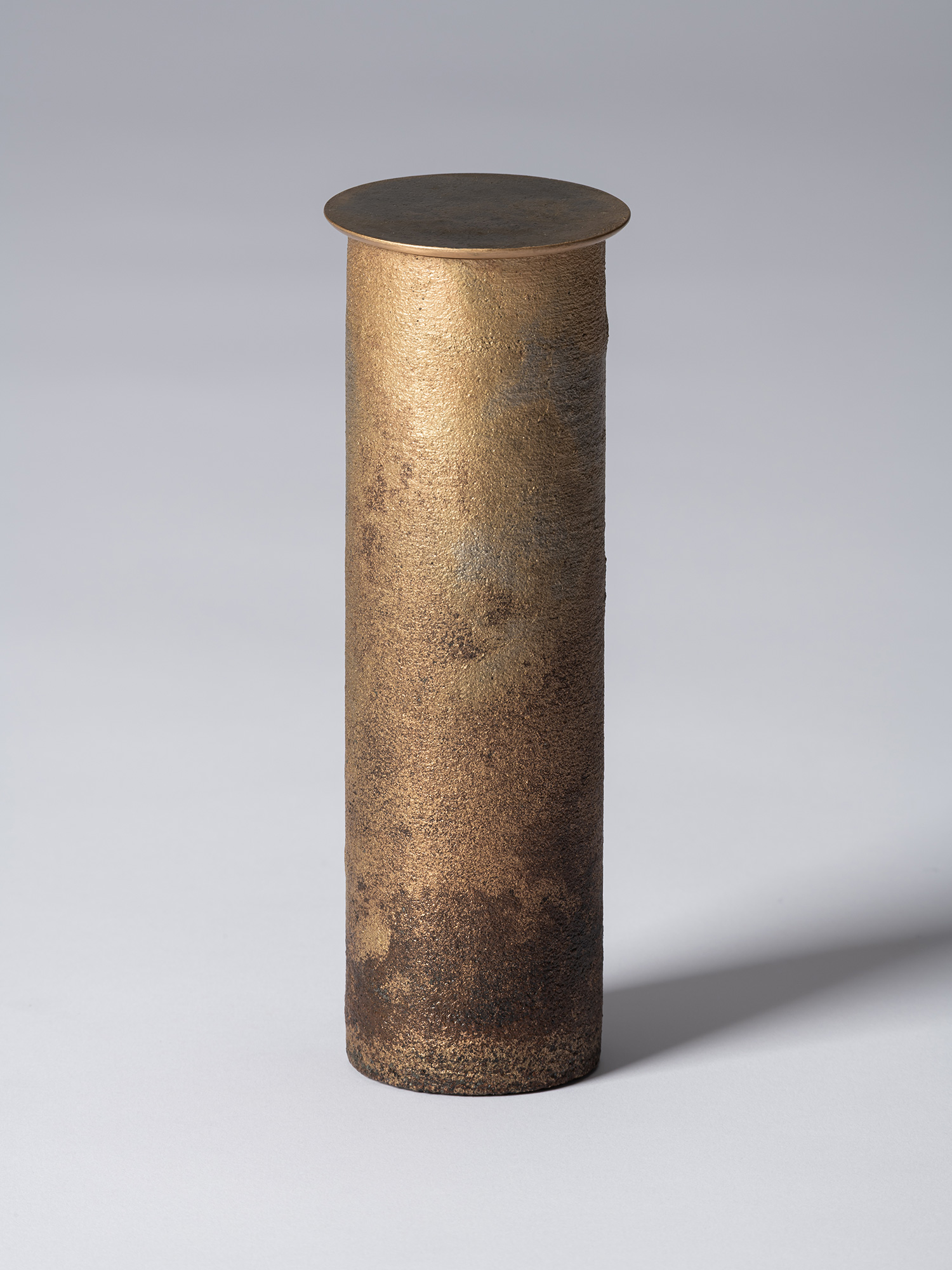 View of Koji Hatakeyama’s bronze as Bronze II No. 32, a tall, slender cylindrical bronze vessel...