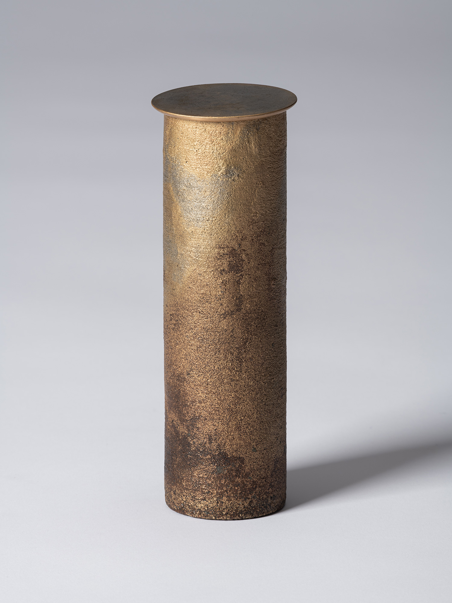 View of Koji Hatakeyama’s bronze as Bronze II No. 32, a tall, slender cylindrical bronze vessel...