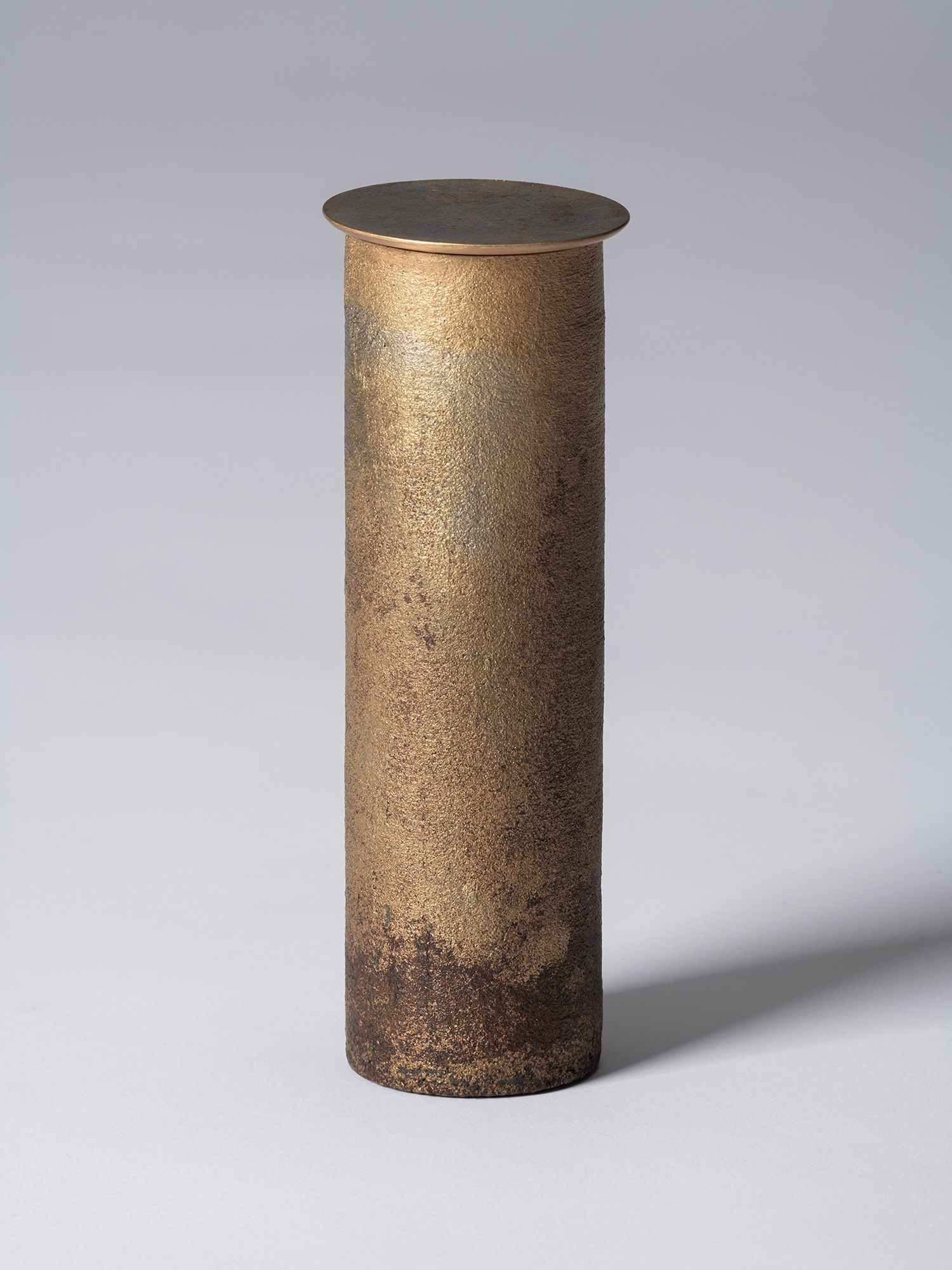 View of Koji Hatakeyama’s bronze as Bronze II No. 32, a tall, slender cylindrical bronze vessel...