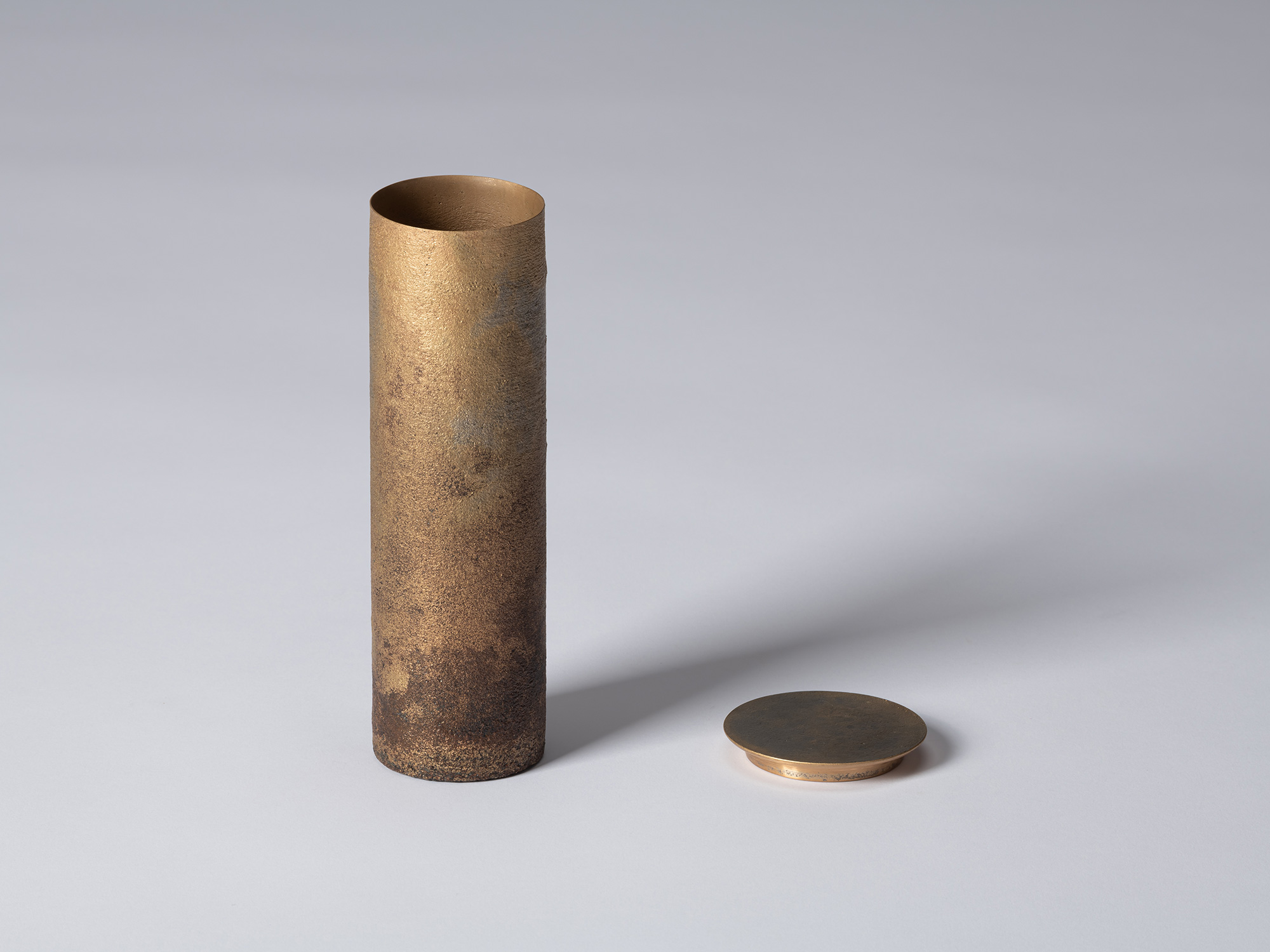 Koji Hatakeyama’s bronze as Bronze II No. 32 with its disc-shaped lid removed and placed beside...