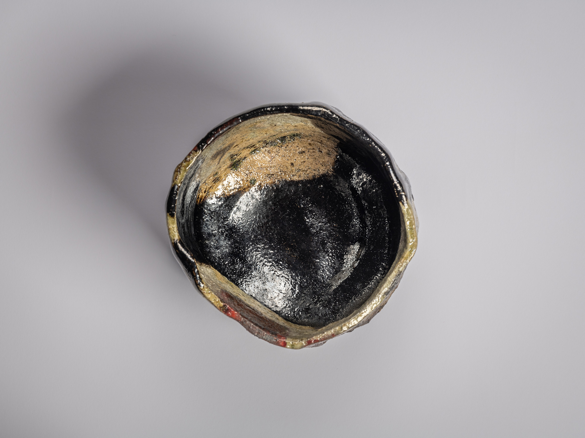 Interior of Kōshū (Mountain Peak) by Raku Jikinyū XV, showing the irregular rim and glossy black-glazed...