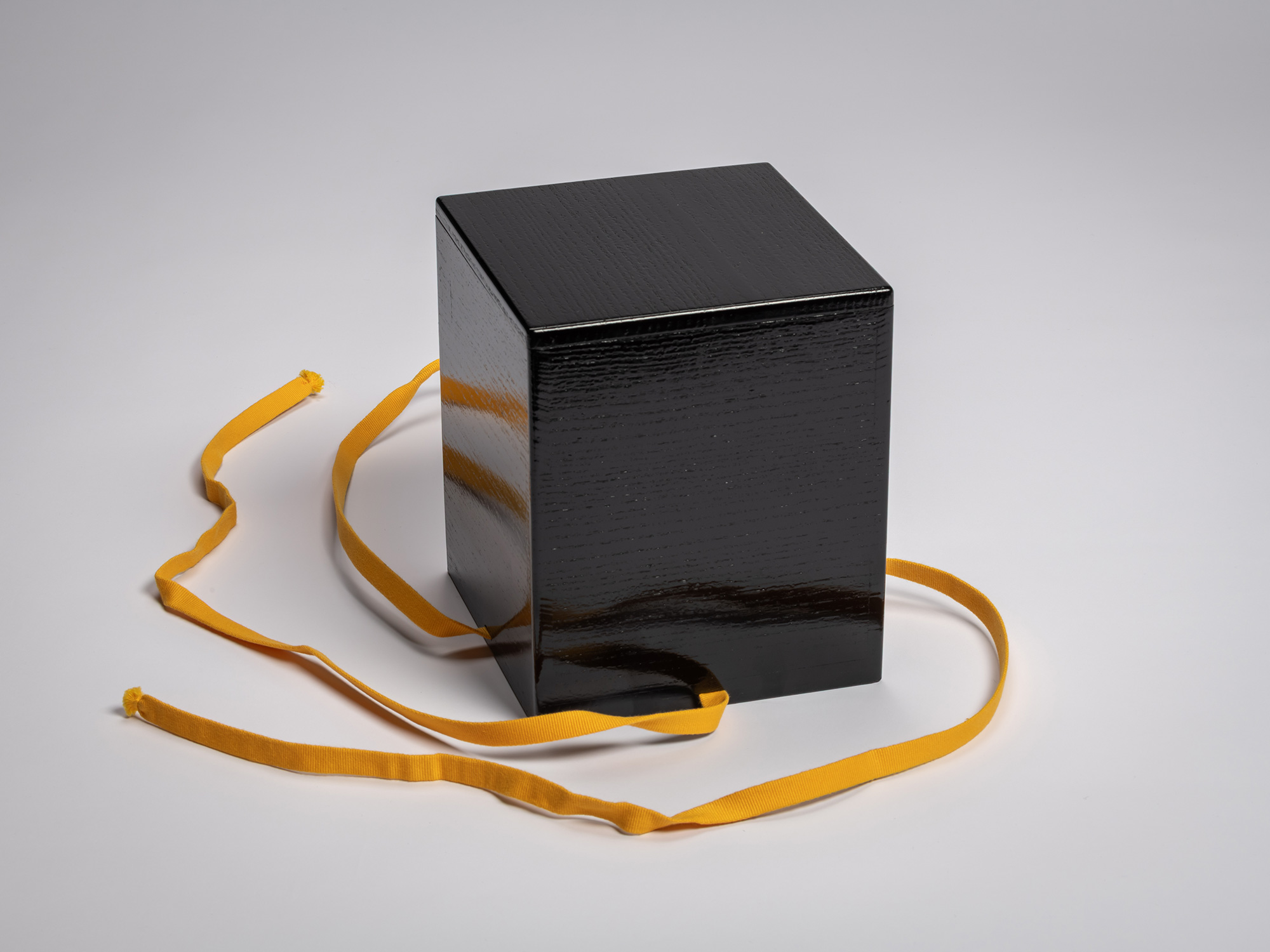 Black lacquered outer storage box for Kōshū (Mountain Peak) by Raku Jikinyū XV, shown with the...
