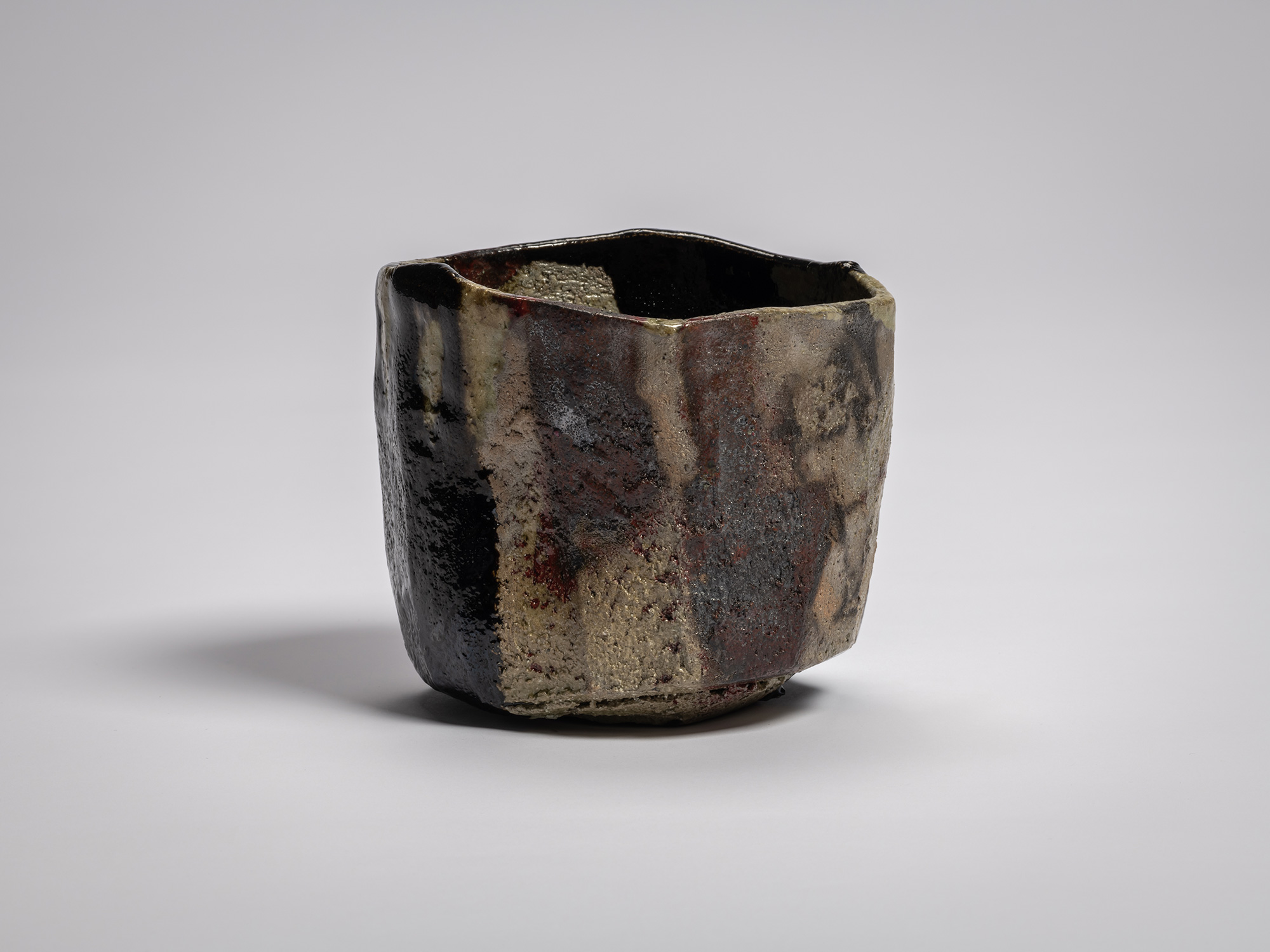 Kōshū (Mountain Peak) by Raku Jikinyū XV, showing an angular side with mottled gray, brown, and...