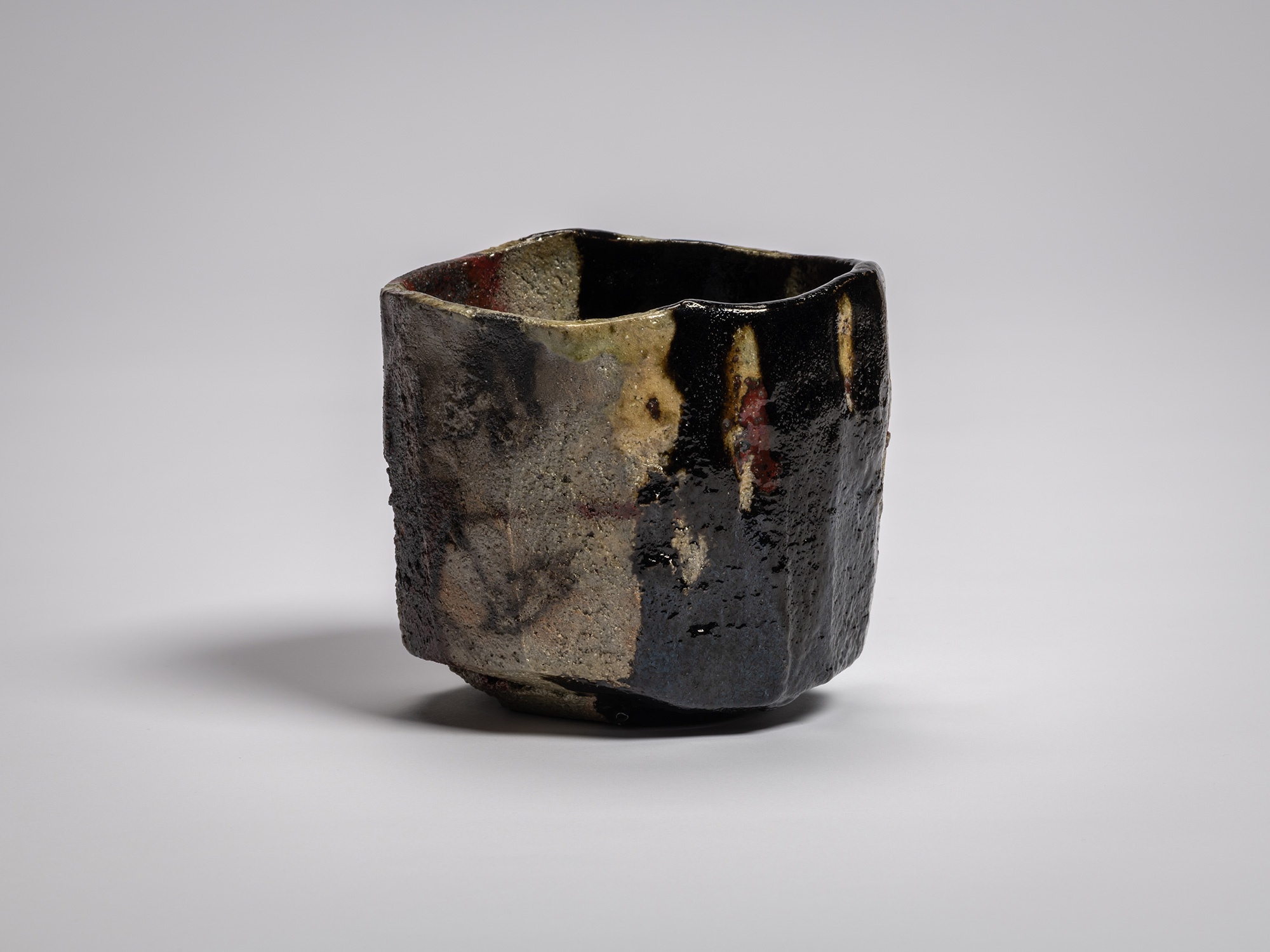 Kōshū (Mountain Peak) by Raku Jikinyū XV, showing a squared side with exposed gray and tan clay...